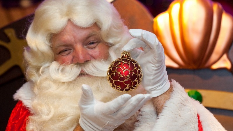 Santa nákupy v ruke má guľu ponúka